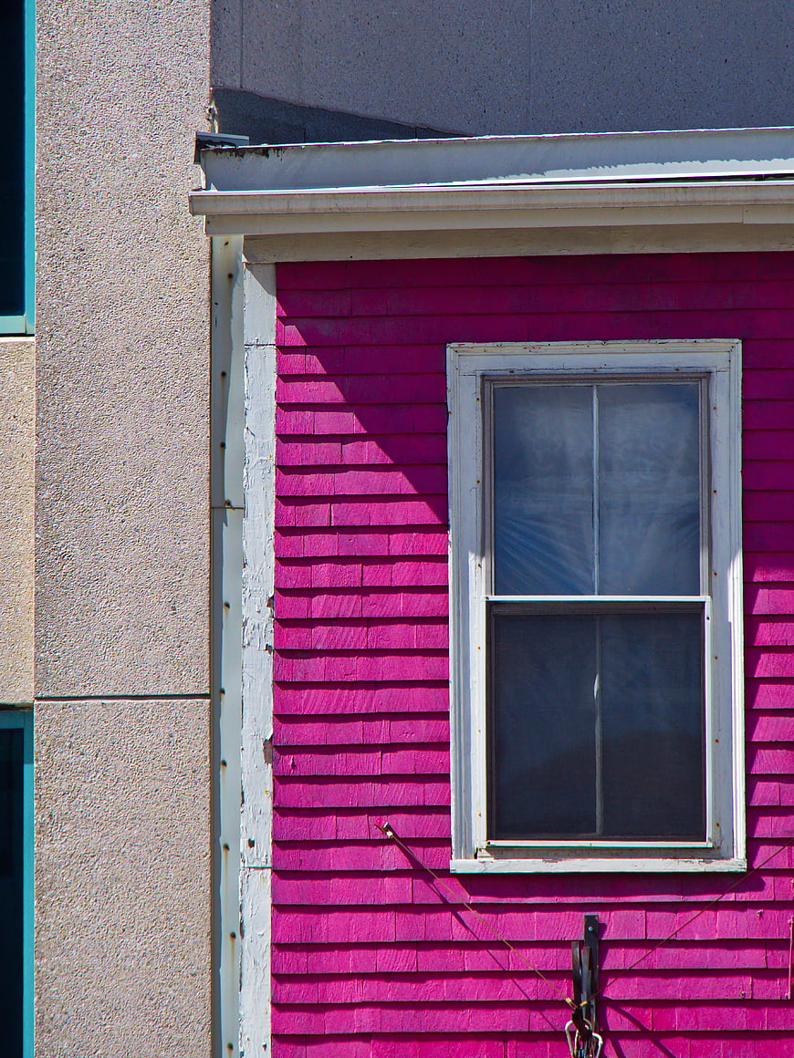Vibrant Pink House Exterior with White Window Frame