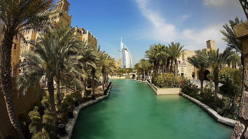Burj Al Arab View From Dubai Creek With Lush Palm Trees