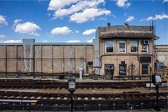 Old Railway Signal Tower and Tracks Under Blue Sky