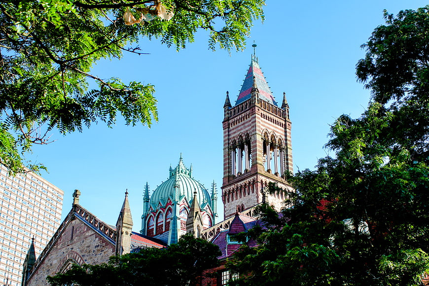 Ornate Gothic Church Tower Framed by Green Trees