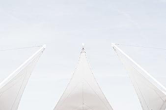 Low angle view of white architectural tent structures against sky