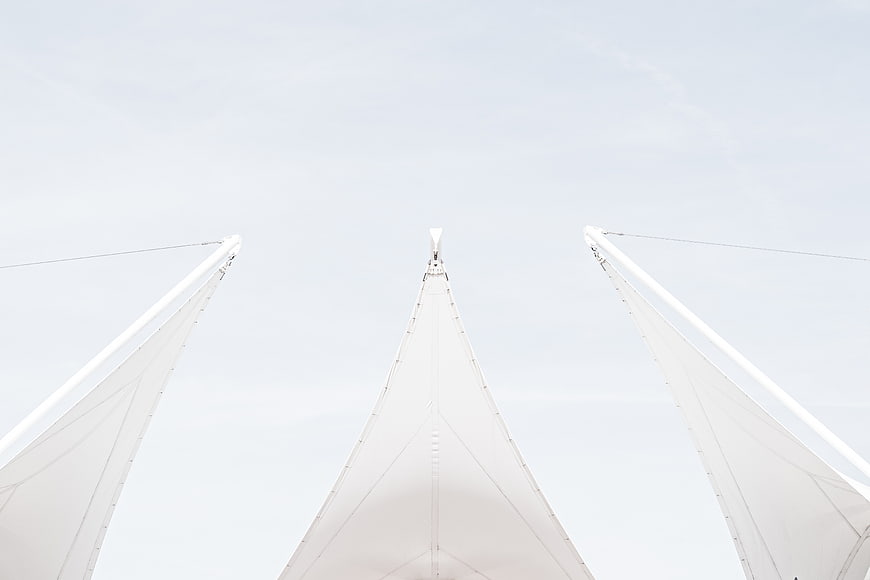 Low angle view of white architectural tent structures against sky