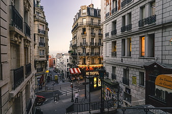 Parisian street scene with Metro entrance and Haussmann architecture
