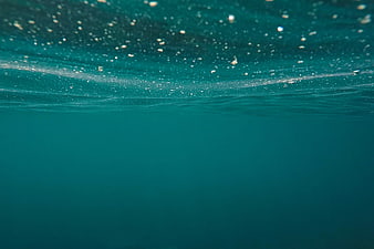 Underwater View of Turquoise Ocean Surface With Bubbles