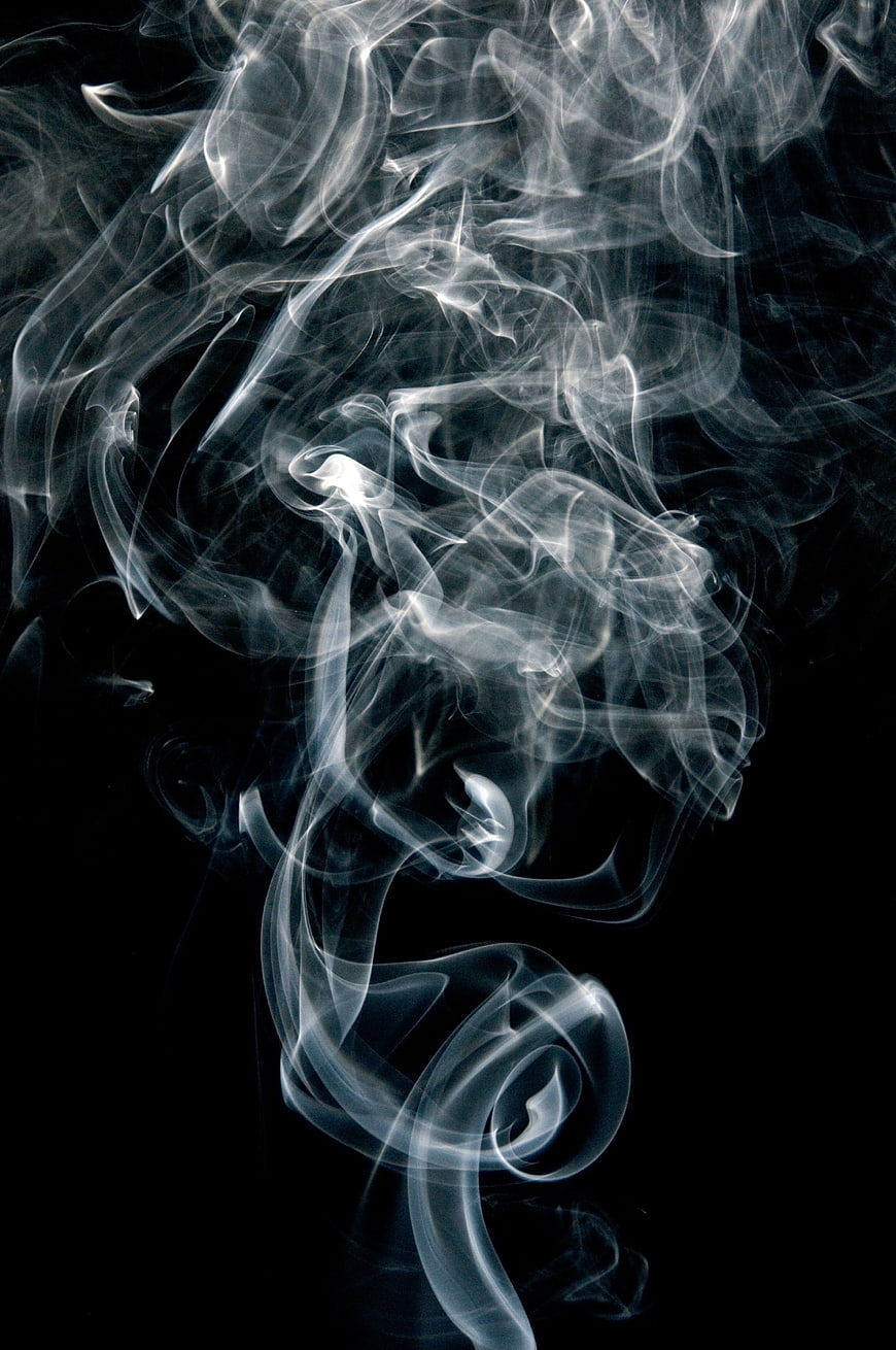 Abstract White Smoke Swirls on Black Background