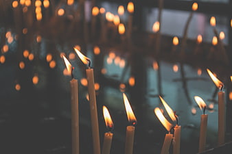 Lit Candles in a Dimly Lit Church Interior