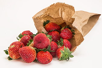 Fresh Red Strawberries Spilling from Brown Paper Bag