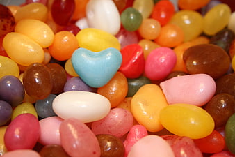 Close-up of colorful sugar-coated candies with a blue heart-shaped sweet
