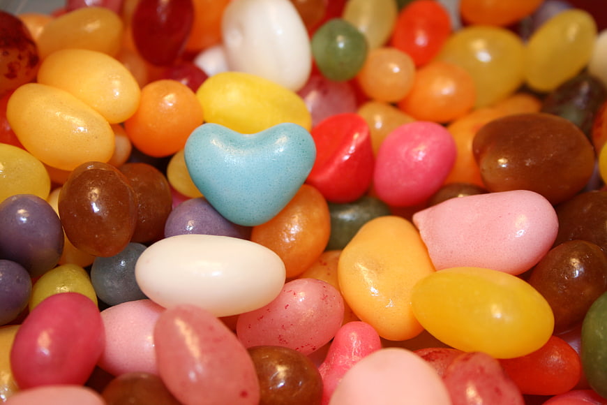 Close-up of colorful sugar-coated candies with a blue heart-shaped sweet