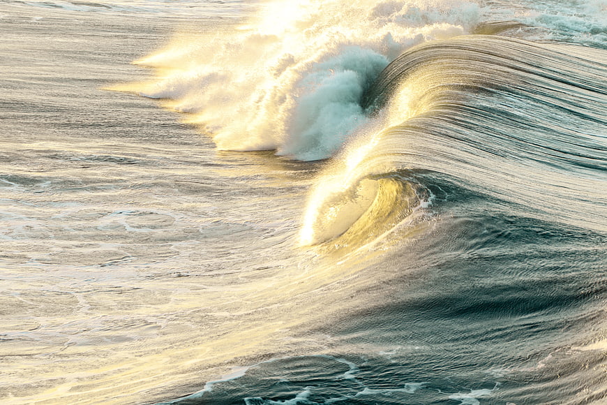 Golden Hour Ocean Wave Breaking with Sunlight