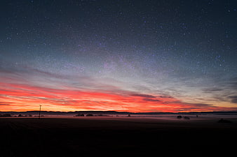 Starry Night Sky Over Misty Autumn Landscape at Dawn