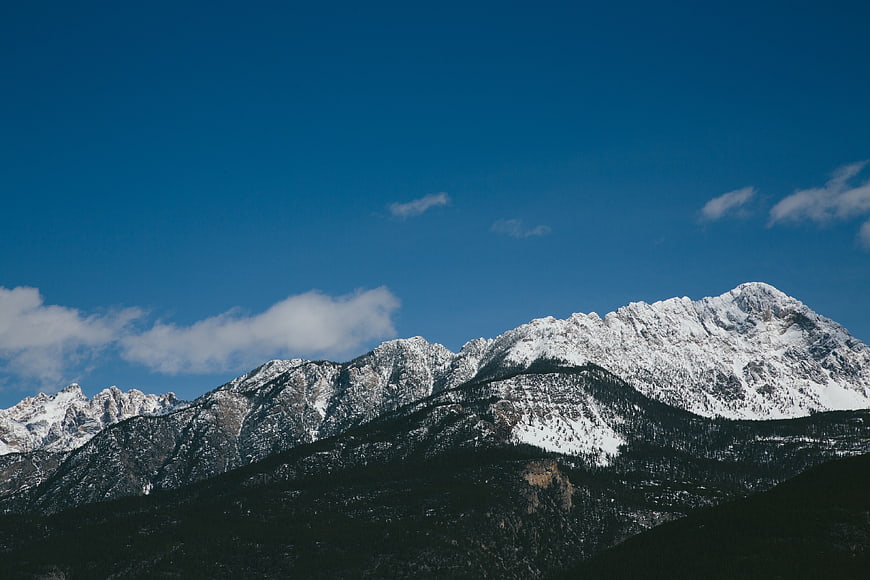 Snow-Capped Mountain Peaks Against a Deep Blue Sky