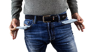 Man turning out empty pockets on white background