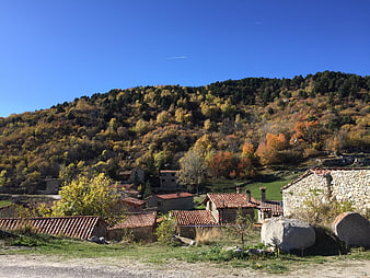 Rustic stone village nestled in autumn hillside landscape