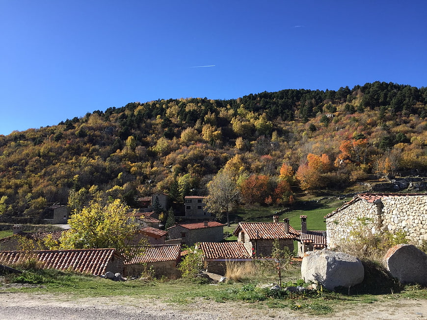 Rustic stone village nestled in autumn hillside landscape