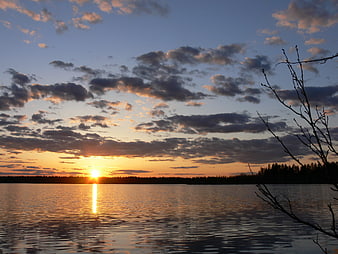 Serene Lake Sunset with Golden Sunlight and Clouds