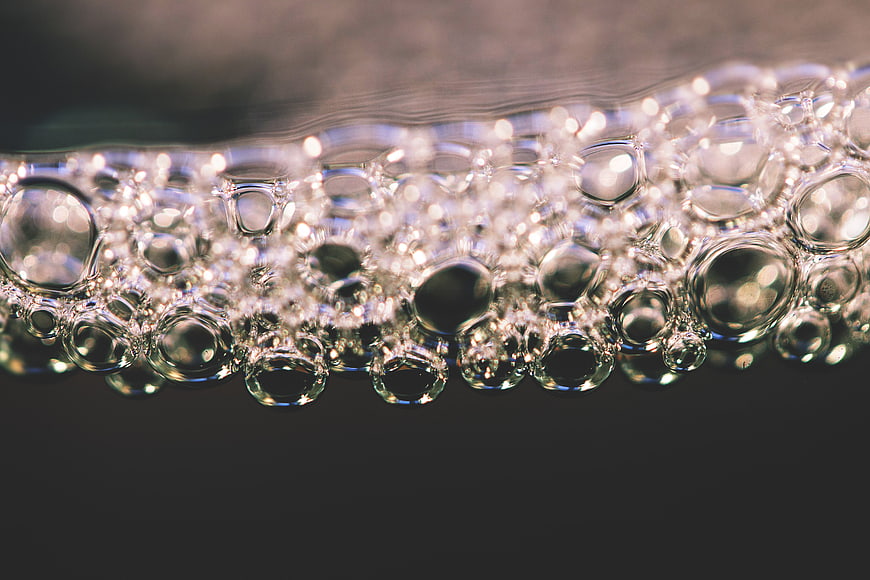 Close-up of sparkling water bubbles with dark background
