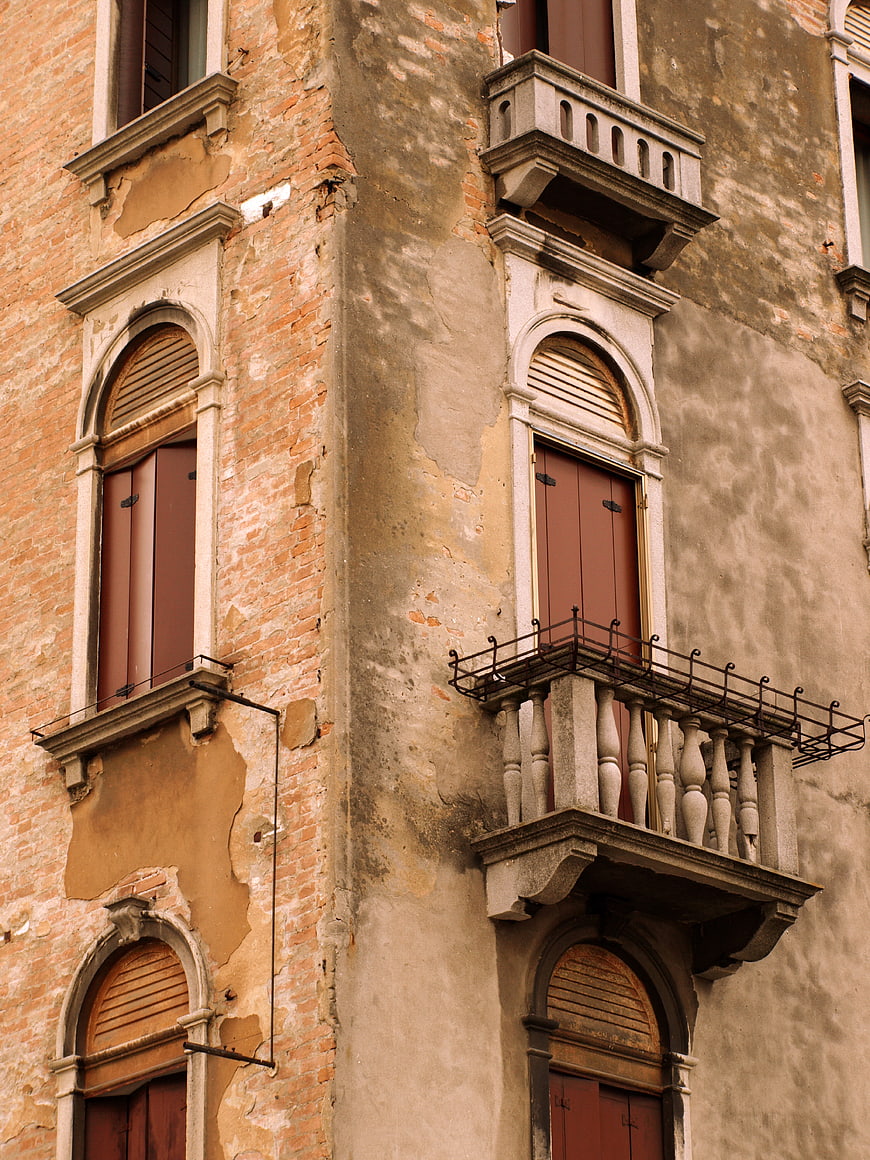 Weathered European Building Facade with Balconies