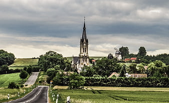 Rural Church and Windmill on Green Hillside