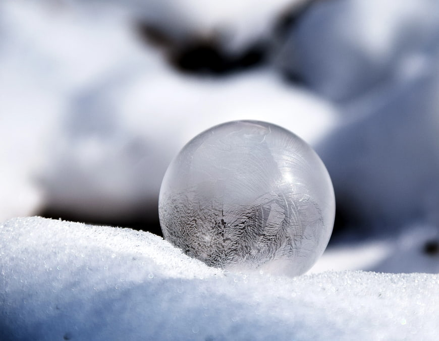 Close-up of a frozen ice sphere on snow