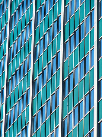 Abstract teal and blue glass building facade pattern