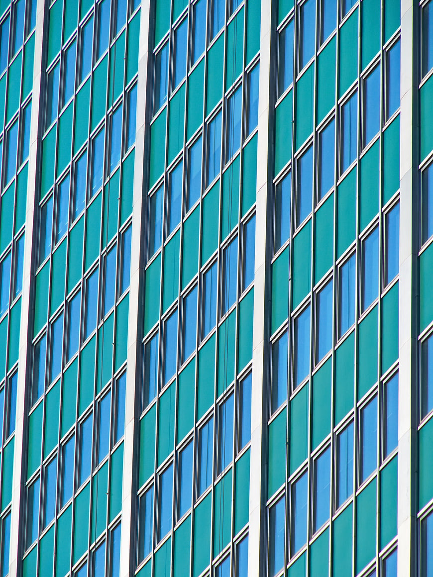 Abstract teal and blue glass building facade pattern