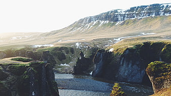 Mossy Canyon with River and Snow-Capped Mountains