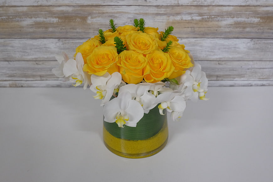 Yellow Roses and White Orchids in Decorative Vase