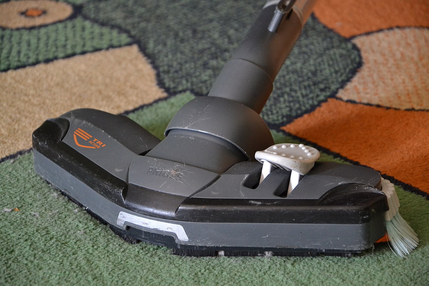 Close-up of Philips vacuum cleaner head on patterned carpet
