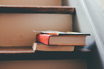 Stack of Books on Wooden Stairs