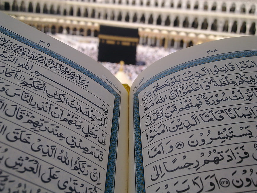 Quran with Kaaba in Background at Masjid al-Haram