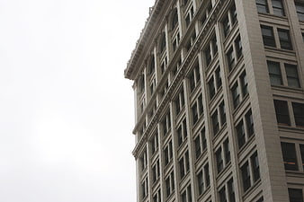 Low angle view of classic urban architecture against white sky