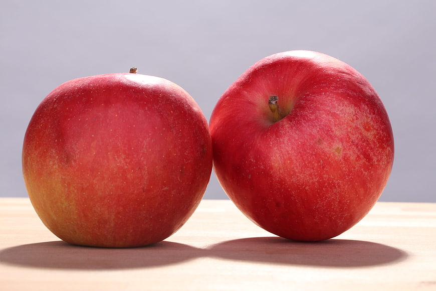 Two Red Apples on Wooden Table