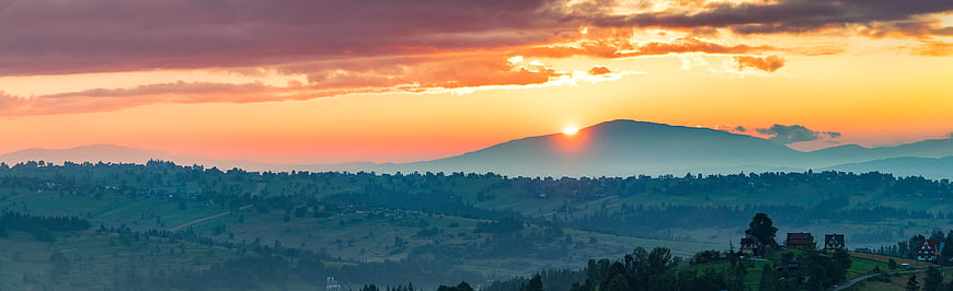 Panoramic sunset over rolling hills and mountains in Poland