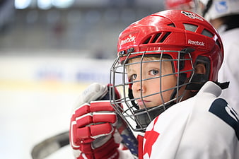 Young Ice Hockey Player in Red Helmet Looking Back