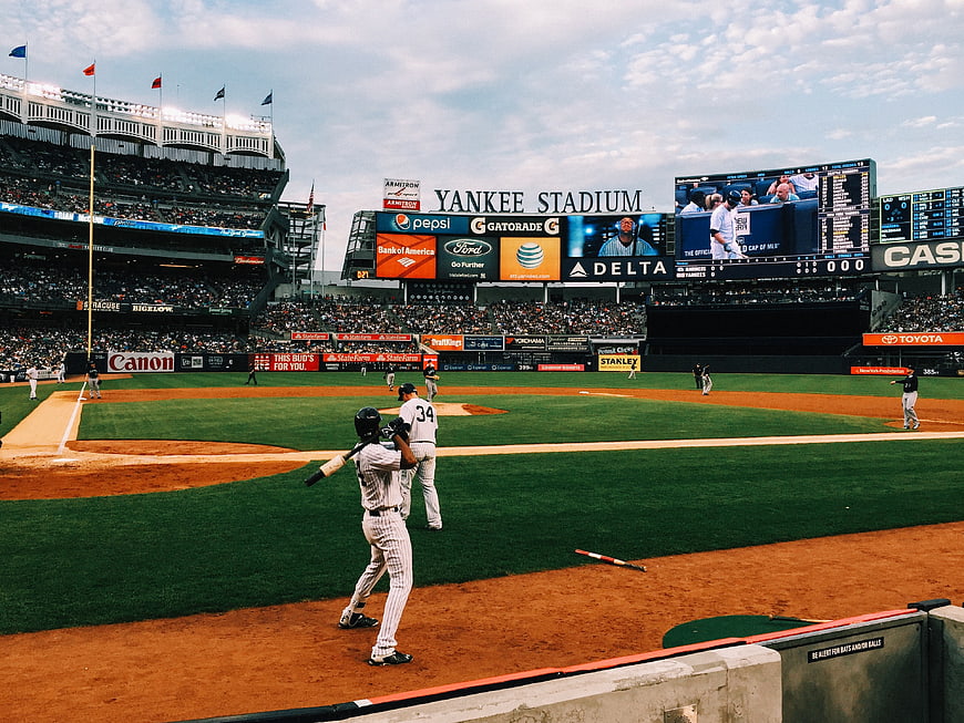 Baseball players warming up at Yankee Stadium field