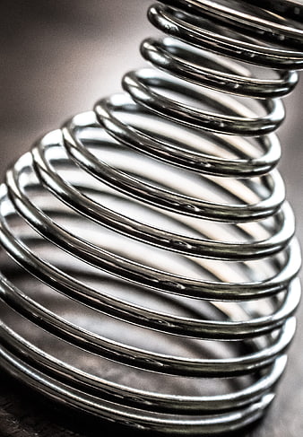 Close-up of shiny metallic spiral spring coil