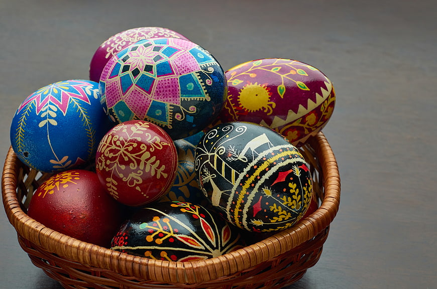 Colorful Hand-Painted Easter Eggs in Wicker Basket
