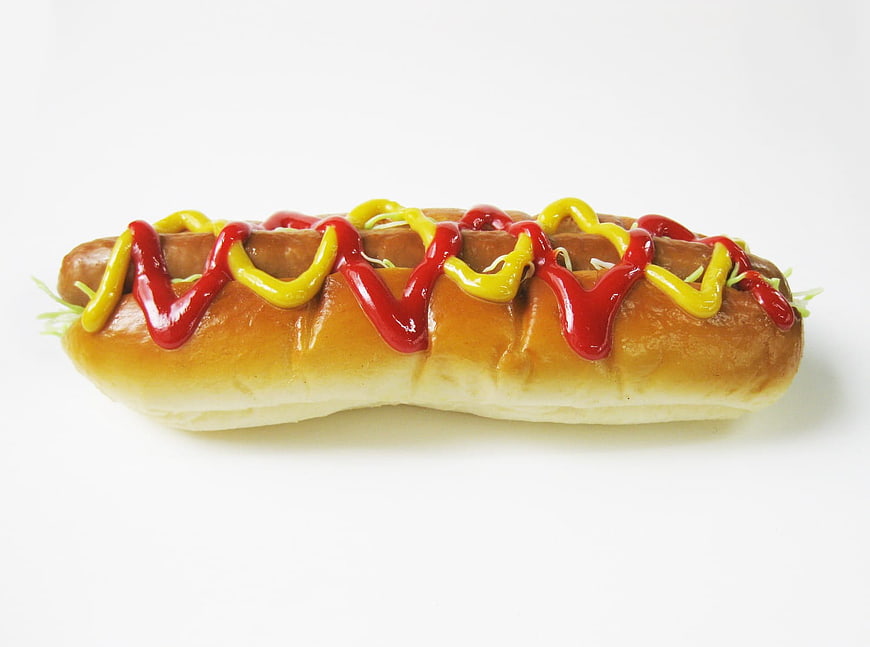Classic Hot Dog with Ketchup and Mustard on White Background