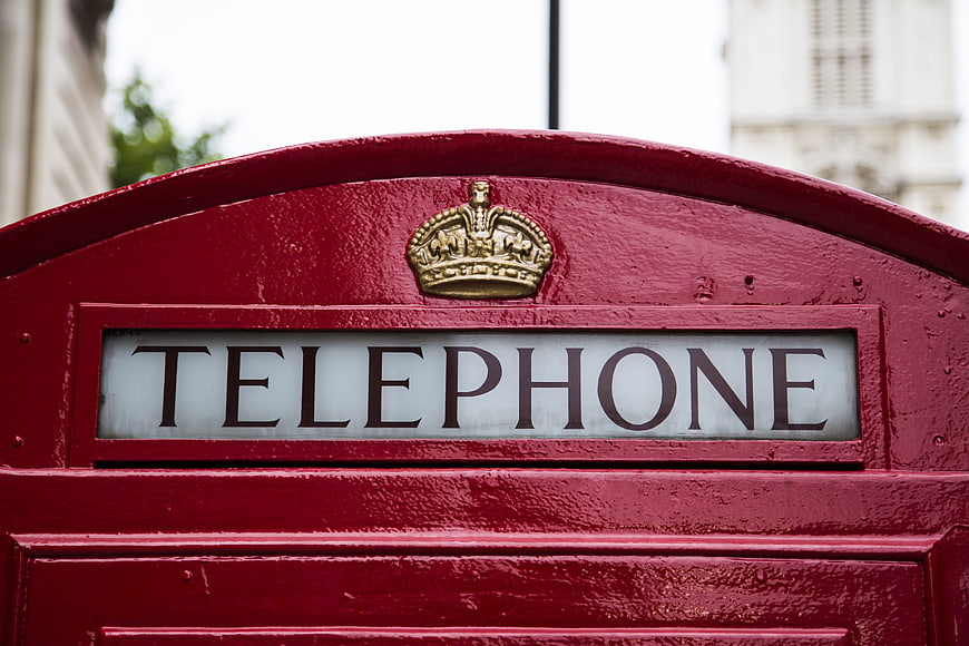 Close-up of classic red British telephone box with crown emblem