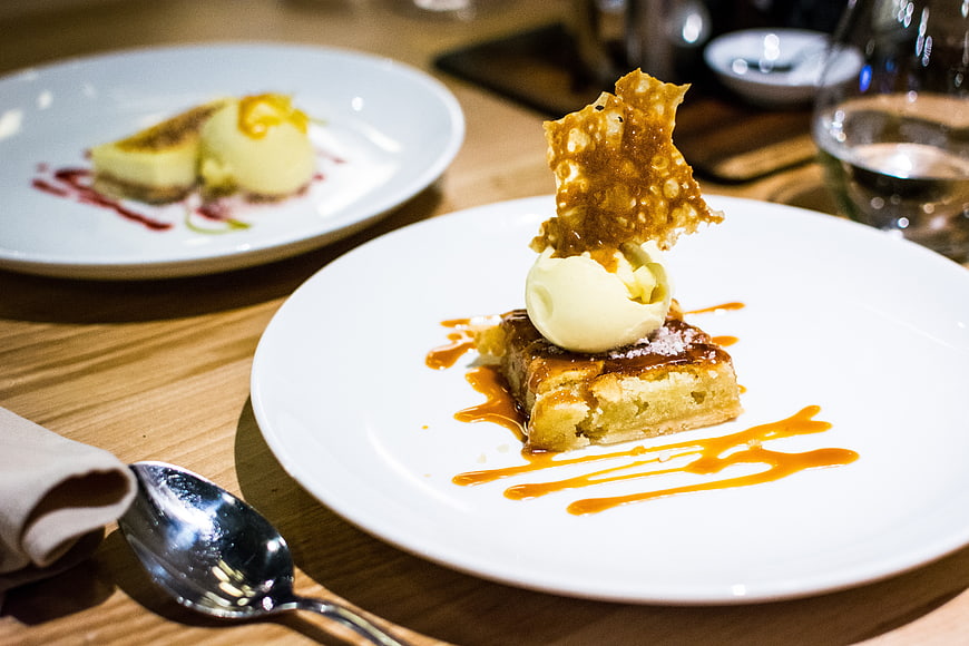Gourmet dessert with caramel sauce and ice cream on white plate