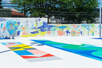 Colorful outdoor art playground with painted mural wall