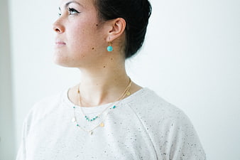 Woman Wearing Turquoise Earrings and Layered Necklaces