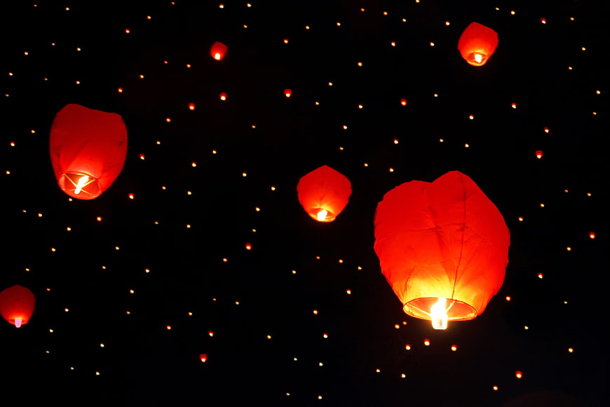Red sky lanterns floating in the night sky