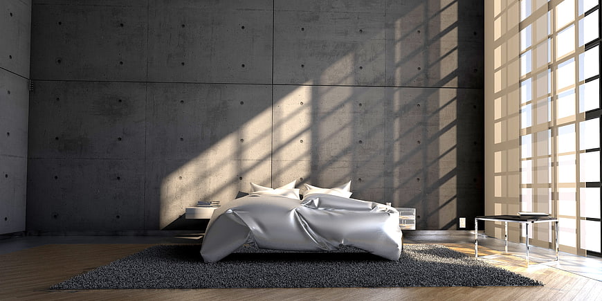 Modern minimalist bedroom with concrete walls and sunlight