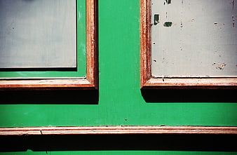Abstract Green Wall with Weathered Wooden Window Frames