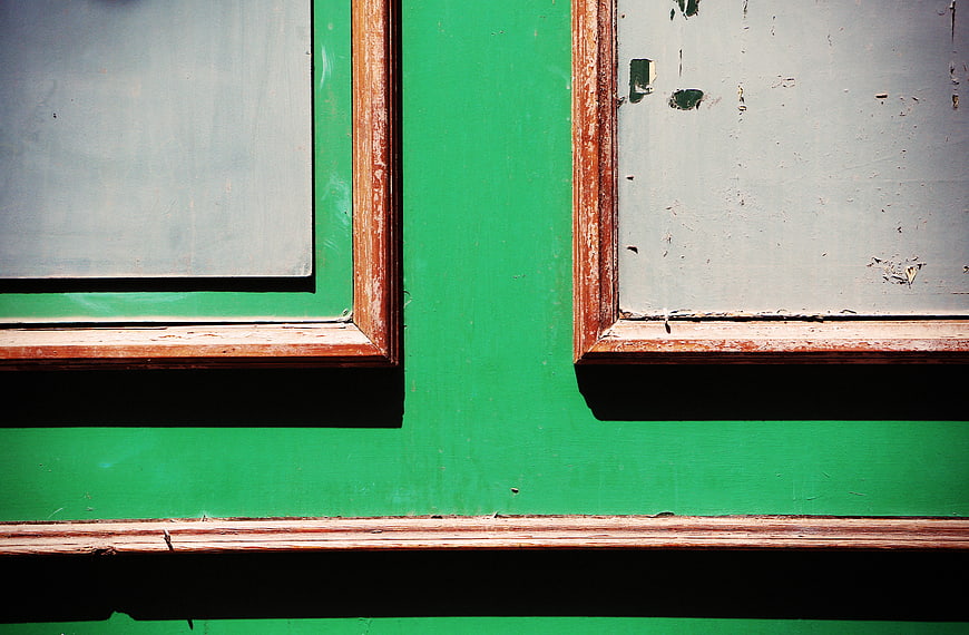 Abstract Green Wall with Weathered Wooden Window Frames