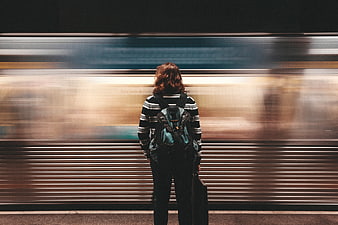 Woman waiting for subway train with motion blur background