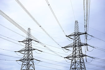 High Voltage Power Lines and Pylons Against Sky