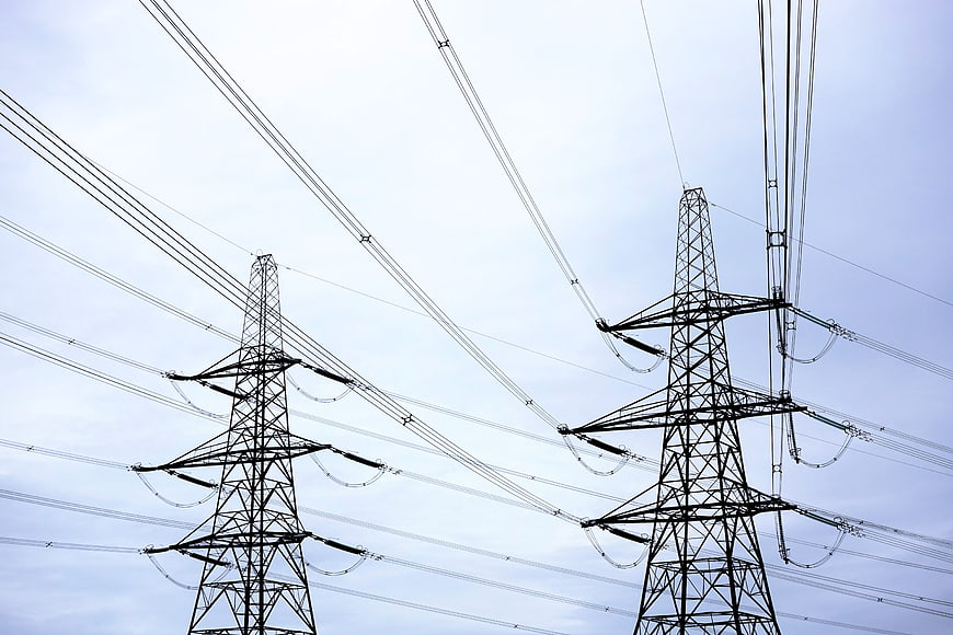 High Voltage Power Lines and Pylons Against Sky